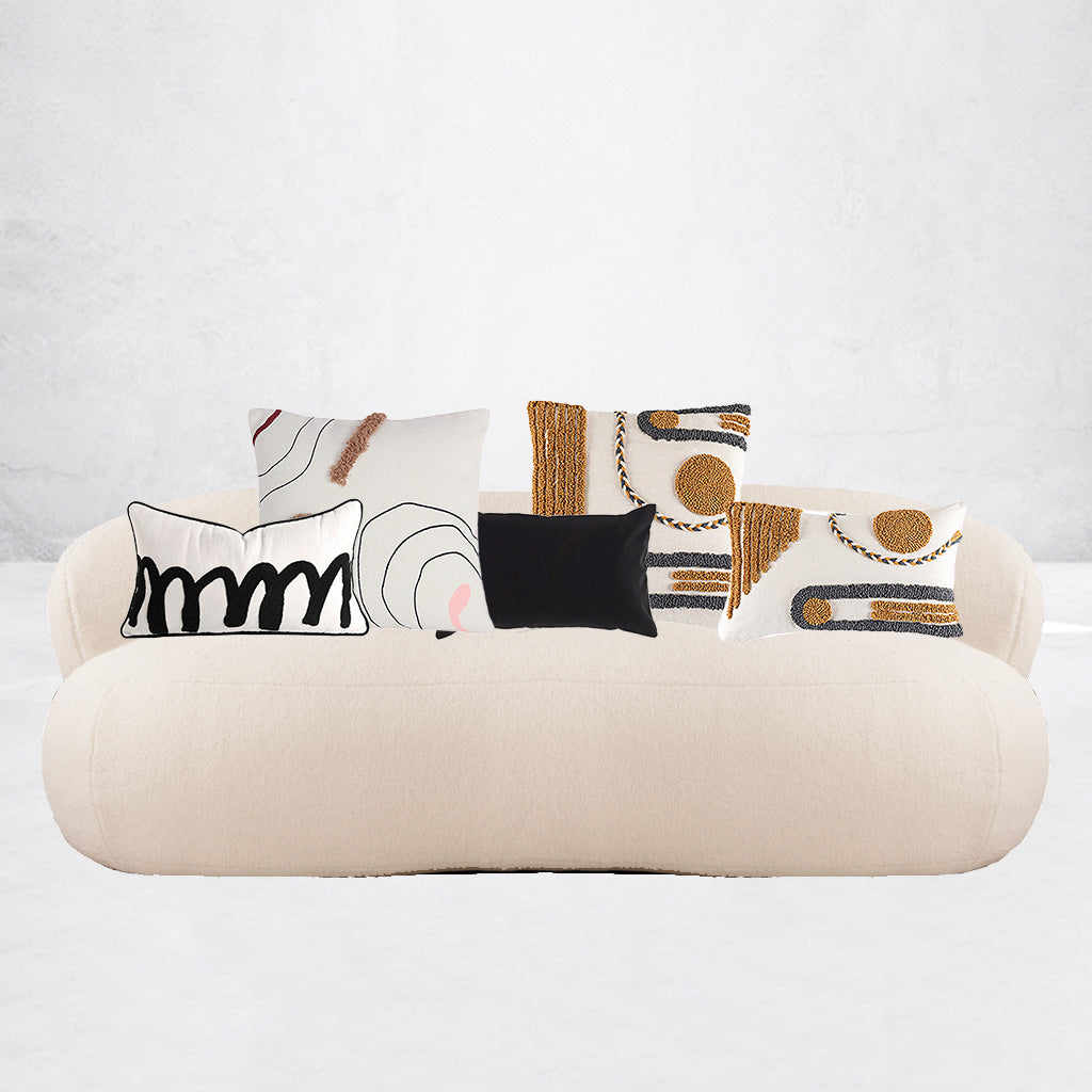 soft cushion covers with abtract design on a cream couch by maoma art
